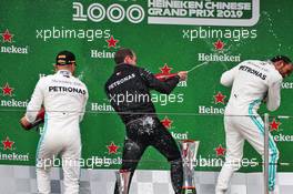 (L to R): Valtteri Bottas (FIN) Mercedes AMG F1 celebrates his second position on the podium Marcus Dudley (GBR) Mercedes AMG F1 Performance Engineer and race winner Lewis Hamilton (GBR) Mercedes AMG F1. 14.04.2019. Formula 1 World Championship, Rd 3, Chinese Grand Prix, Shanghai, China, Race Day.