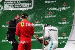 Sebastian Vettel (GER) Ferrari celebrates his third position on the podium with race winner Lewis Hamilton (GBR) Mercedes AMG F1 and Marcus Dudley (GBR) Mercedes AMG F1 Performance Engineer. 14.04.2019. Formula 1 World Championship, Rd 3, Chinese Grand Prix, Shanghai, China, Race Day.