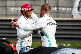 (L to R): second placed Lewis Hamilton (GBR) Mercedes AMG F1 congratulates team mate Valtteri Bottas (FIN) Mercedes AMG F1 on his pole position in qualifying parc ferme. 13.04.2019. Formula 1 World Championship, Rd 3, Chinese Grand Prix, Shanghai, China, Qualifying Day.