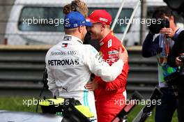 (L to R): Valtteri Bottas (FIN) Mercedes AMG F1 with Sebastian Vettel (GER) Ferrari in qualifying parc ferme. 13.04.2019. Formula 1 World Championship, Rd 3, Chinese Grand Prix, Shanghai, China, Qualifying Day.