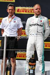 (L to R): Nathan Divey (GBR) Mercedes AMG F1 No1 Mechanic and Valtteri Bottas (FIN) Mercedes AMG F1 on the podium. 23.06.2019. Formula 1 World Championship, Rd 8, French Grand Prix, Paul Ricard, France, Race Day.