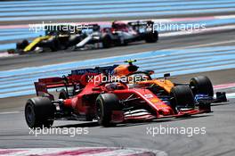 Sebastian Vettel (GER) Ferrari SF90 and Lando Norris (GBR) McLaren MCL34 battle for position. 23.06.2019. Formula 1 World Championship, Rd 8, French Grand Prix, Paul Ricard, France, Race Day.