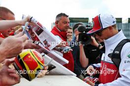 Kimi Raikkonen (FIN) Alfa Romeo Racing signs autographs for the fans. 12.07.2019. Formula 1 World Championship, Rd 10, British Grand Prix, Silverstone, England, Practice Day.