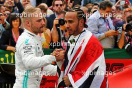 Race winner Lewis Hamilton (GBR) Mercedes AMG F1 celebrates with team mate Valtteri Bottas (FIN) Mercedes AMG F1 in parc ferme. 14.07.2019. Formula 1 World Championship, Rd 10, British Grand Prix, Silverstone, England, Race Day.