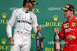 (L to R): Race winner Lewis Hamilton (GBR) Mercedes AMG F1 celebrates on the podium with third placed Charles Leclerc (MON) Ferrari. 14.07.2019. Formula 1 World Championship, Rd 10, British Grand Prix, Silverstone, England, Race Day.