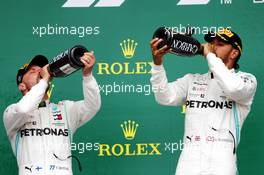 (L to R): second placed Valtteri Bottas (FIN) Mercedes AMG F1 celebrates on the podium with race winner Lewis Hamilton (GBR) Mercedes AMG F1. 14.07.2019. Formula 1 World Championship, Rd 10, British Grand Prix, Silverstone, England, Race Day.