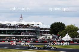 Valtteri Bottas (FIN) Mercedes AMG F1 W10 and Lewis Hamilton (GBR) Mercedes AMG F1 W10 battle for the lead of the race. 14.07.2019. Formula 1 World Championship, Rd 10, British Grand Prix, Silverstone, England, Race Day.