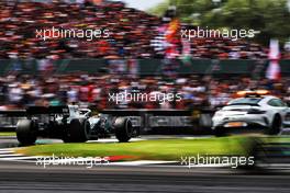 Lewis Hamilton (GBR) Mercedes AMG F1 W10 leads behind the FIA Safety Car. 14.07.2019. Formula 1 World Championship, Rd 10, British Grand Prix, Silverstone, England, Race Day.