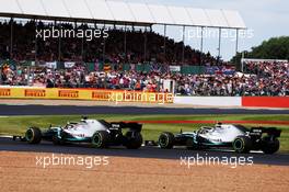 Valtteri Bottas (FIN) Mercedes AMG F1 W10 and Lewis Hamilton (GBR) Mercedes AMG F1 W10 battle for the lead of the race. 14.07.2019. Formula 1 World Championship, Rd 10, British Grand Prix, Silverstone, England, Race Day.