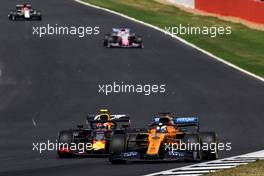 Carlos Sainz Jr (ESP) McLaren MCL34 and Pierre Gasly (FRA) Red Bull Racing RB15 battle for position. 14.07.2019. Formula 1 World Championship, Rd 10, British Grand Prix, Silverstone, England, Race Day.