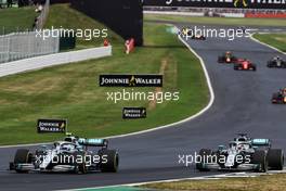 Valtteri Bottas (FIN) Mercedes AMG F1 W10 and Lewis Hamilton (GBR) Mercedes AMG F1 W10 battle for position. 14.07.2019. Formula 1 World Championship, Rd 10, British Grand Prix, Silverstone, England, Race Day.