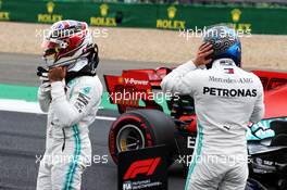 (L to R): Lewis Hamilton (GBR) Mercedes AMG F1 with team mate and pole sitter Valtteri Bottas (FIN) Mercedes AMG F1 in qualifying parc ferme. 13.07.2019. Formula 1 World Championship, Rd 10, British Grand Prix, Silverstone, England, Qualifying Day.