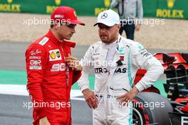 (L to R): third placed Charles Leclerc (MON) Ferrari with pole sitter Valtteri Bottas (FIN) Mercedes AMG F1 in qualifying parc ferme. 13.07.2019. Formula 1 World Championship, Rd 10, British Grand Prix, Silverstone, England, Qualifying Day.