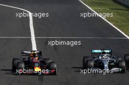 (L to R): Max Verstappen (NLD) Red Bull Racing RB15 and Lewis Hamilton (GBR) Mercedes AMG F1 W10 battle for the lead of the race. 04.08.2019. Formula 1 World Championship, Rd 12, Hungarian Grand Prix, Budapest, Hungary, Race Day.