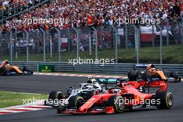 Sebastian Vettel (GER) Ferrari SF90 and Valtteri Bottas (FIN) Mercedes AMG F1 W10 battle for position. 04.08.2019. Formula 1 World Championship, Rd 12, Hungarian Grand Prix, Budapest, Hungary, Race Day.