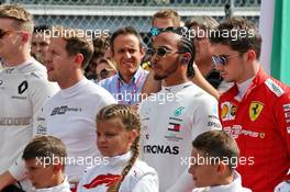 Lewis Hamilton (GBR) Mercedes AMG F1 and Charles Leclerc (MON) Ferrari as the grid observes the national anthem. 08.09.2019. Formula 1 World Championship, Rd 14, Italian Grand Prix, Monza, Italy, Race Day.