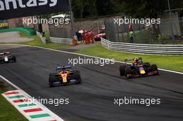 Carlos Sainz Jr (ESP) McLaren MCL34 and Alexander Albon (THA) Red Bull Racing RB15 battle for position. 08.09.2019. Formula 1 World Championship, Rd 14, Italian Grand Prix, Monza, Italy, Race Day.