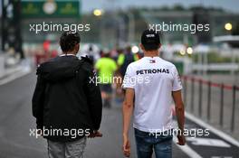 (L to R): Lewis Hamilton (GBR) Mercedes AMG F1 with Esteban Ocon (FRA) Mercedes AMG F1 Reserve Driver. 11.10.2019. Formula 1 World Championship, Rd 17, Japanese Grand Prix, Suzuka, Japan, Practice Day.