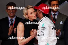 (L to R): Princess Charlene of Monaco celebrates with race winner Lewis Hamilton (GBR) Mercedes AMG F1 on the podium. 26.05.2019. Formula 1 World Championship, Rd 6, Monaco Grand Prix, Monte Carlo, Monaco, Race Day.