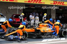Lando Norris (GBR) McLaren MCL34 pushed back down the pit lane by mechanics during the race. 27.10.2019. Formula 1 World Championship, Rd 18, Mexican Grand Prix, Mexico City, Mexico, Race Day.