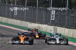 Lando Norris (GBR) McLaren MCL34 and Valtteri Bottas (FIN) Mercedes AMG F1 W10 battle for position. 27.10.2019. Formula 1 World Championship, Rd 18, Mexican Grand Prix, Mexico City, Mexico, Race Day.