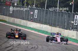 Max Verstappen (NLD) Red Bull Racing RB15 and Sergio Perez (MEX) Racing Point F1 Team RP19 battle for position. 27.10.2019. Formula 1 World Championship, Rd 18, Mexican Grand Prix, Mexico City, Mexico, Race Day.