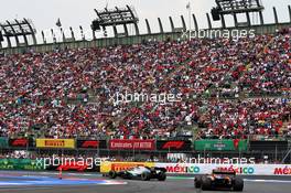 Lewis Hamilton (GBR) Mercedes AMG F1 W10 and Lando Norris (GBR) McLaren MCL34. 26.10.2019. Formula 1 World Championship, Rd 18, Mexican Grand Prix, Mexico City, Mexico, Qualifying Day.