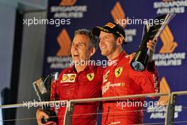 Race winner Sebastian Vettel (GER) Ferrari celebrates on the podium with Inaki Rueda (ESP) Ferrari Race Strategist. 22.09.2019. Formula 1 World Championship, Rd 15, Singapore Grand Prix, Marina Bay Street Circuit, Singapore, Race Day.