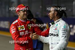 Sebastian Vettel (GER) Ferrari SF90 and Lewis Hamilton (GBR) Mercedes AMG F1 W10. 21.09.2019. Formula 1 World Championship, Rd 15, Singapore Grand Prix, Marina Bay Street Circuit, Singapore, Qualifying Day.