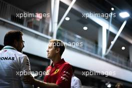 Sebastian Vettel (GER) Ferrari with Gwen Lagrue, Head of Mercedes AMG Driver Development. 19.09.2019. Formula 1 World Championship, Rd 15, Singapore Grand Prix, Marina Bay Street Circuit, Singapore, Preparation Day.