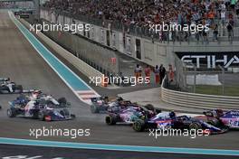 Pierre Gasly (FRA) Scuderia Toro Rosso STR14 makes contace with Sergio Perez (MEX) Racing Point F1 Team RP19 and Lance Stroll (CDN) Racing Point F1 Team RP19 at the start of the race. 01.12.2019. Formula 1 World Championship, Rd 21, Abu Dhabi Grand Prix, Yas Marina Circuit, Abu Dhabi, Race Day.