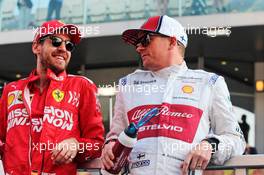 (L to R): Sebastian Vettel (GER) Ferrari with Kimi Raikkonen (FIN) Alfa Romeo Racing on the drivers parade. 01.12.2019. Formula 1 World Championship, Rd 21, Abu Dhabi Grand Prix, Yas Marina Circuit, Abu Dhabi, Race Day.