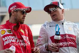 (L to R): Sebastian Vettel (GER) Ferrari and Kimi Raikkonen (FIN) Alfa Romeo Racing on the drivers parade. 01.12.2019. Formula 1 World Championship, Rd 21, Abu Dhabi Grand Prix, Yas Marina Circuit, Abu Dhabi, Race Day.