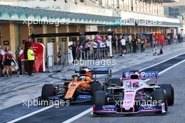 Lance Stroll (CDN) Racing Point F1 Team RP19 and Carlos Sainz Jr (ESP) McLaren MCL34 in the pits. 04.12.2019. Formula 1 Testing, Yas Marina Circuit, Abu Dhabi, Wednesday.