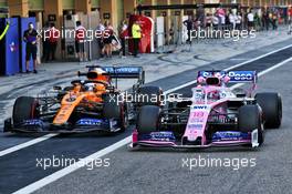 Lance Stroll (CDN) Racing Point F1 Team RP19 and Carlos Sainz Jr (ESP) McLaren MCL34 in the pits. 04.12.2019. Formula 1 Testing, Yas Marina Circuit, Abu Dhabi, Wednesday.