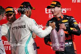 Lewis Hamilton (GBR) Mercedes AMG F1 celebrates his second position and World Championship on the podium with Max Verstappen (NLD) Red Bull Racing.                                03.11.2019. Formula 1 World Championship, Rd 19, United States Grand Prix, Austin, Texas, USA, Race Day.