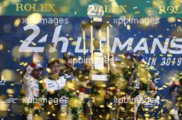 (L to R): Race winners Kazuki Nakajima (JPN); Sebastien Buemi (SUI); and Fernando Alonso (ESP) #08 Toyota Gazoo Racing Toyota TS050 Hybrid celebrate on the podium. 16.06.2019. FIA World Endurance Championship, Le Mans 24 Hours, Race, Le Mans, France. Sunday.