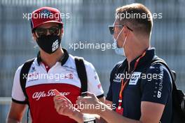 (L to R): Antonio Giovinazzi (ITA) Alfa Romeo Racing with Daniil Kvyat (RUS) AlphaTauri. 07.08.2020. Formula 1 World Championship, Rd 5, 70th Anniversary Grand Prix, Silverstone, England, Practice Day.