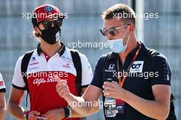 (L to R): Antonio Giovinazzi (ITA) Alfa Romeo Racing with Daniil Kvyat (RUS) AlphaTauri. 07.08.2020. Formula 1 World Championship, Rd 5, 70th Anniversary Grand Prix, Silverstone, England, Practice Day.