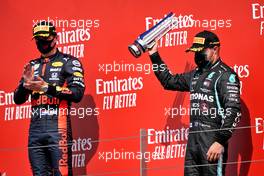 (L to R): Race winner Max Verstappen (NLD) Red Bull Racing with third placed Valtteri Bottas (FIN) Mercedes AMG F1 on the podium. 09.08.2020. Formula 1 World Championship, Rd 5, 70th Anniversary Grand Prix, Silverstone, England, Race Day.
