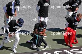Lewis Hamilton (GBR) Mercedes AMG F1 and Sebastian Vettel (GER) Ferrari take a knee on the grid wearing 'Black Lives Matter' and 'End Racism' T-shirts.  05.07.2020. Formula 1 World Championship, Rd 1, Austrian Grand Prix, Spielberg, Austria, Race Day.