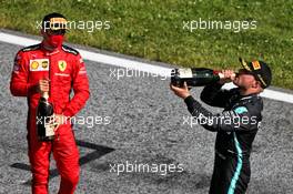 (L to R): Charles Leclerc (MON) Ferrari and race winner Valtteri Bottas (FIN) Mercedes AMG F1 celebrate on the podium. 05.07.2020. Formula 1 World Championship, Rd 1, Austrian Grand Prix, Spielberg, Austria, Race Day.