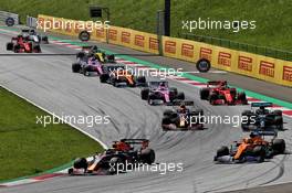 Max Verstappen (NLD) Red Bull Racing RB16 and Lando Norris (GBR) McLaren MCL35 battle for position at the start of the race. 05.07.2020. Formula 1 World Championship, Rd 1, Austrian Grand Prix, Spielberg, Austria, Race Day.