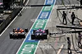 Lando Norris (GBR) McLaren MCL35 and Sergio Perez (MEX) Racing Point F1 Team RP19 exit the pits together. 05.07.2020. Formula 1 World Championship, Rd 1, Austrian Grand Prix, Spielberg, Austria, Race Day.