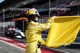 A marshal with a yellow flag in the pits. 27.02.2020. Formula One Testing, Day Two, Barcelona, Spain. Thursday.