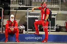 Sebastian Vettel (GER) Ferrari with Antti Kontsas (FIN) Personal Trainer in the pits while the race is stopped. 29.11.2020. Formula 1 World Championship, Rd 15, Bahrain Grand Prix, Sakhir, Bahrain, Race Day.