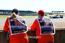 Marshals watch Kimi Raikkonen (FIN) Alfa Romeo Racing C39 in the first practice session. 31.07.2020. Formula 1 World Championship, Rd 4, British Grand Prix, Silverstone, England, Practice Day.
