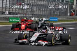 Charles Leclerc (MON) Ferrari SF1000 and Valtteri Bottas (FIN) Mercedes AMG F1 W11 leave the pits behind Romain Grosjean (FRA) Haas F1 Team VF-20. 19.07.2020. Formula 1 World Championship, Rd 3, Hungarian Grand Prix, Budapest, Hungary, Race Day.