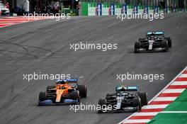 (L to R): Carlos Sainz Jr (ESP) McLaren MCL35 and Valtteri Bottas (FIN) Mercedes AMG F1 W11 battle for the lead of the race. 25.10.2020. Formula 1 World Championship, Rd 12, Portuguese Grand Prix, Portimao, Portugal, Race Day.