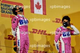 Race winner Sergio Perez (MEX) Racing Point F1 Team celebrates on the podium alongside third placed team mate Lance Stroll (CDN) Racing Point F1 Team. 06.12.2020. Formula 1 World Championship, Rd 16, Sakhir Grand Prix, Sakhir, Bahrain, Race Day.